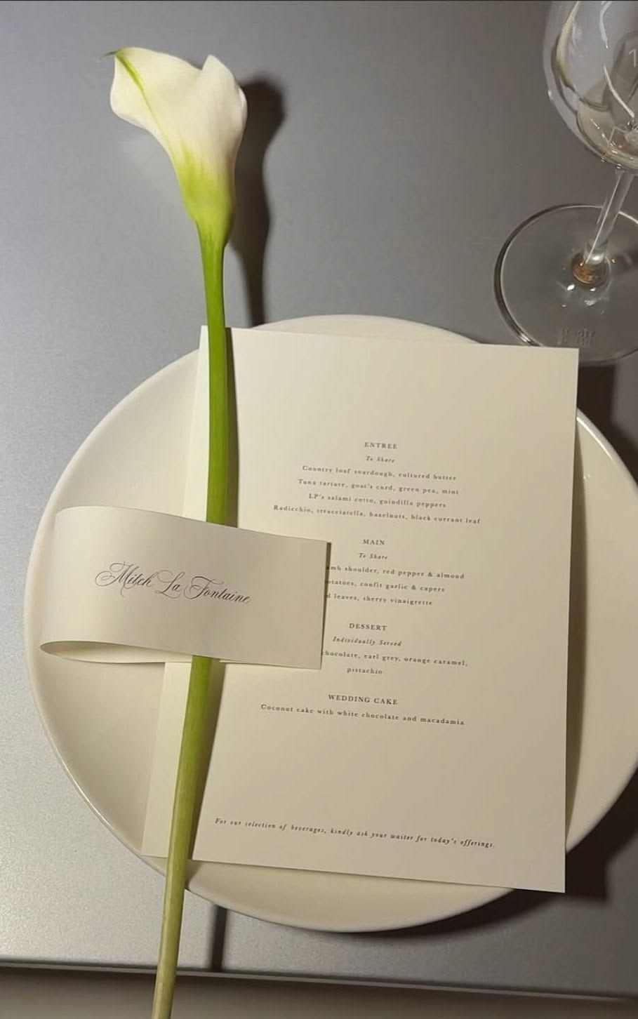 Menu card and calla lily on a plate