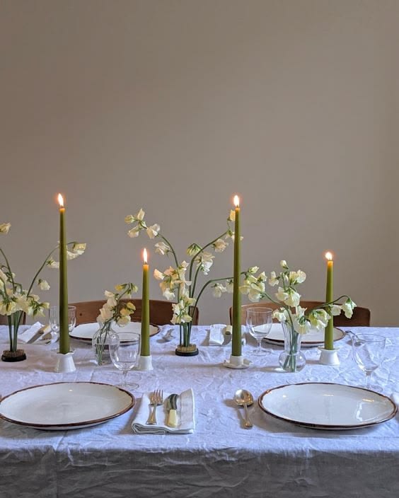 Minimal table with green taper candles