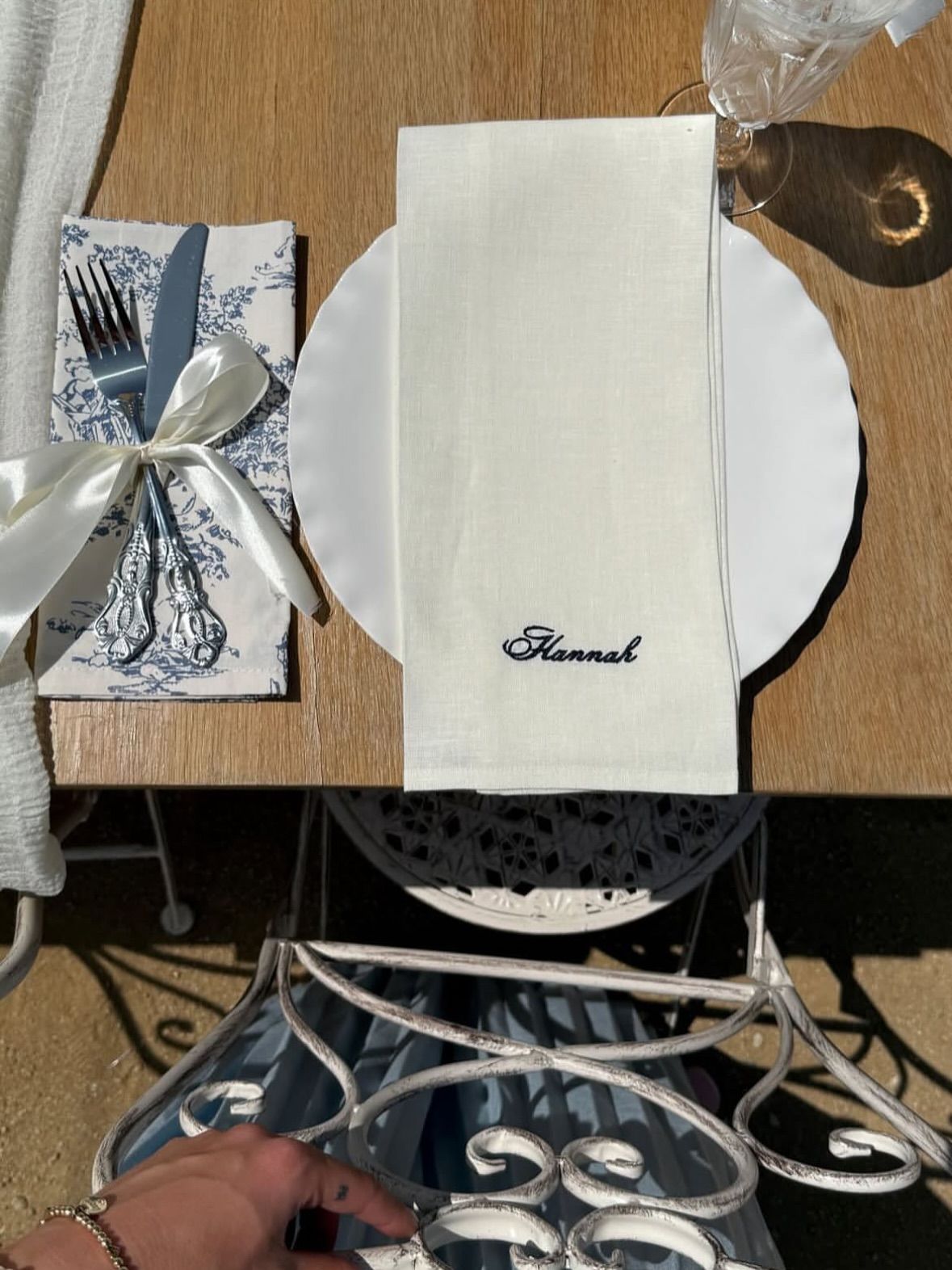 Blue toile place setting with embroidered linen napkin